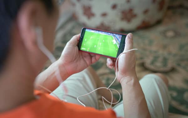 man watching football sport stream smartphone home